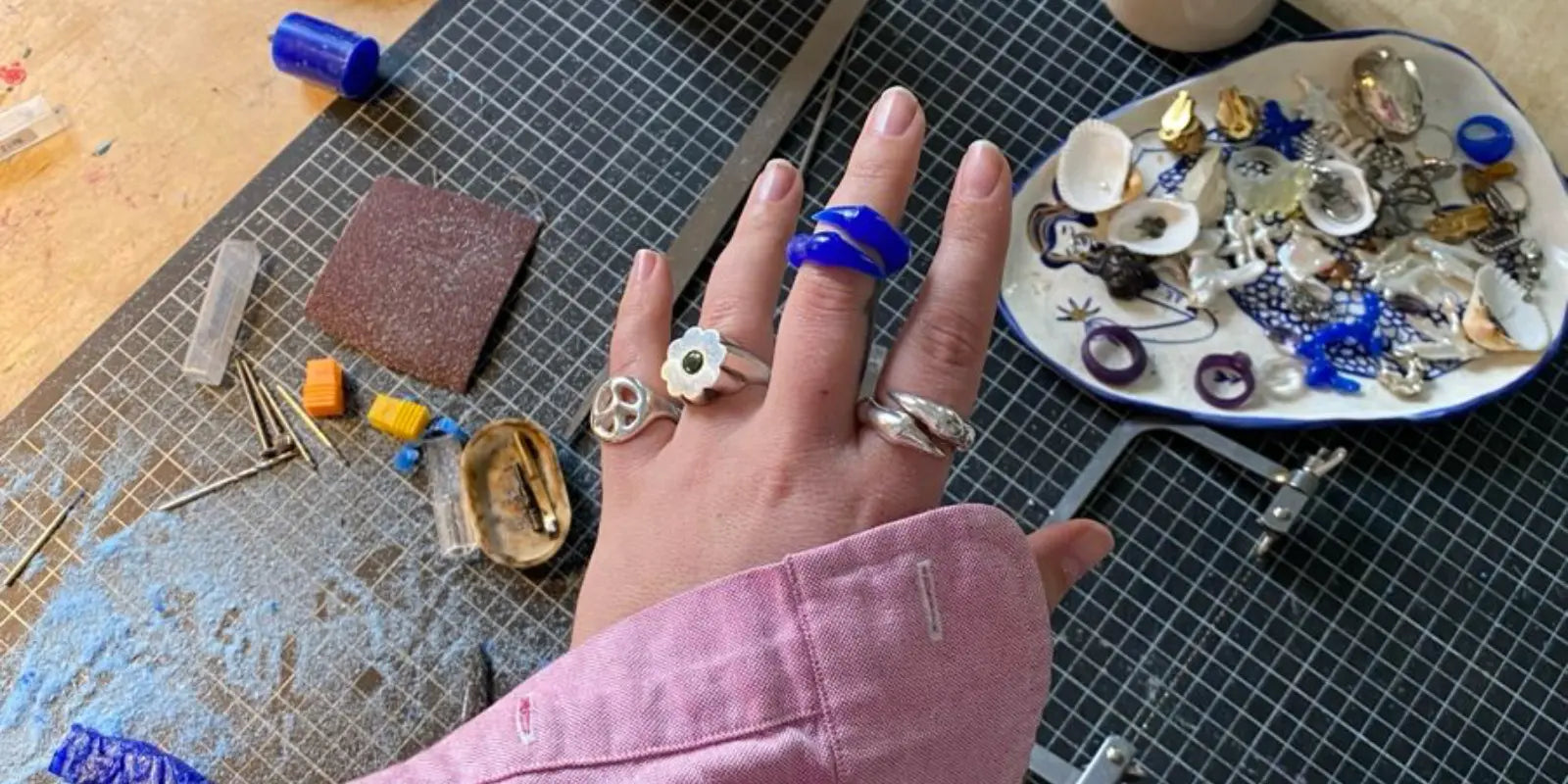 handmade silver jewelry making process in studio workspace